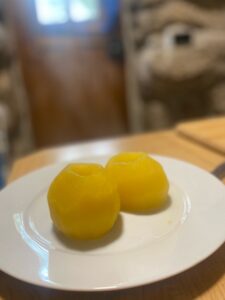 two poached apples on a white plate