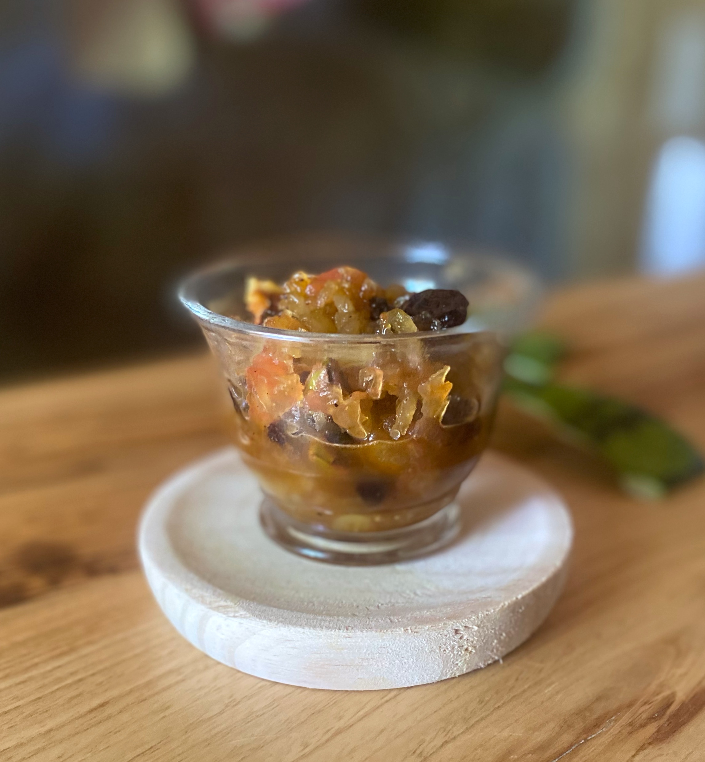 watermelon rind halwa in a glass bowl on a wooden plate