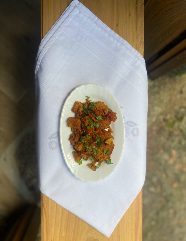 bread upma on white plate and towel