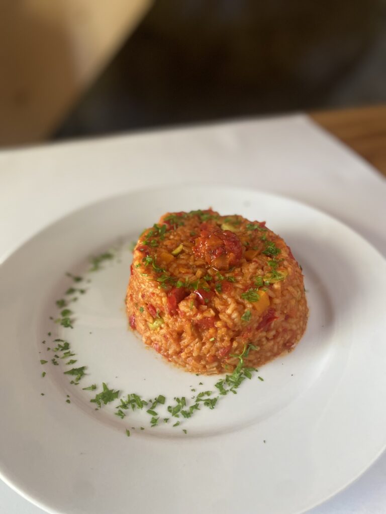 djuvec rice on a white plate, ready to be eaten