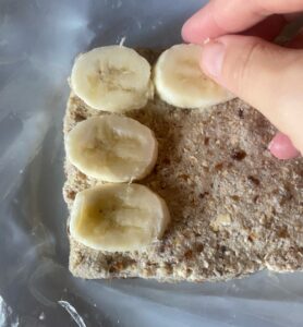 bananas being placed on a cake crust