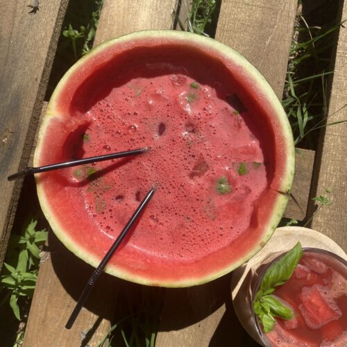 half a watermelon filled with bowle on a wooden background