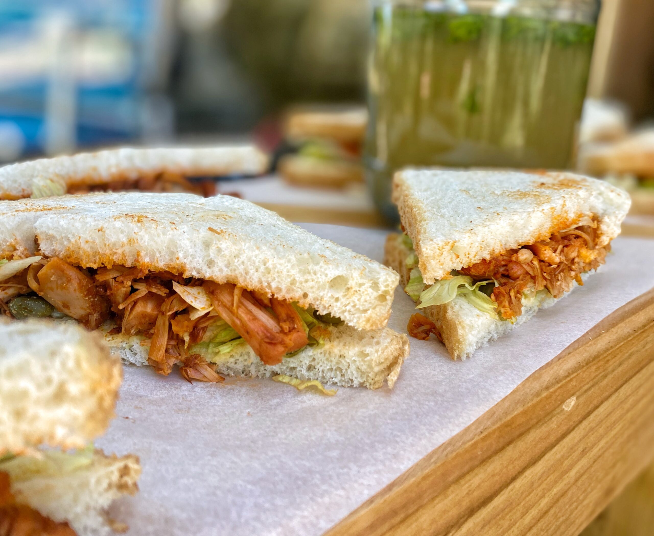 bbq pulled jackfruit sandwiches on a wooden table