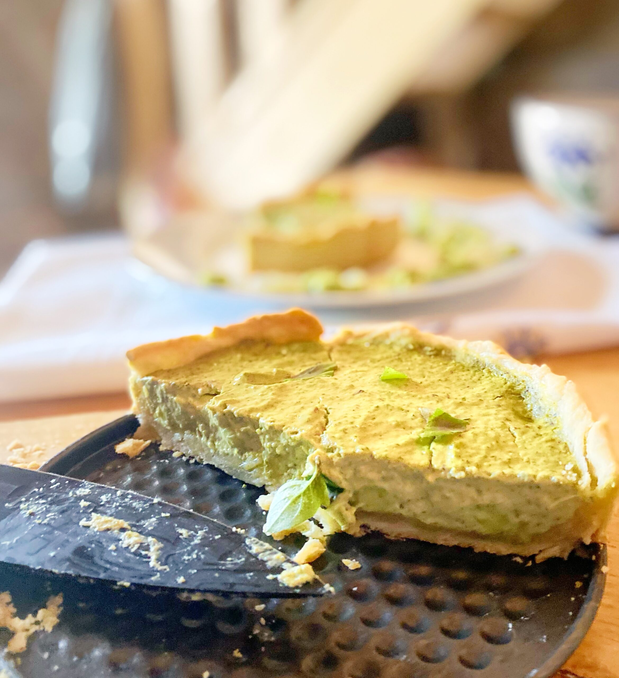 vegan quiche on a tin bottom, placed on a wooden board