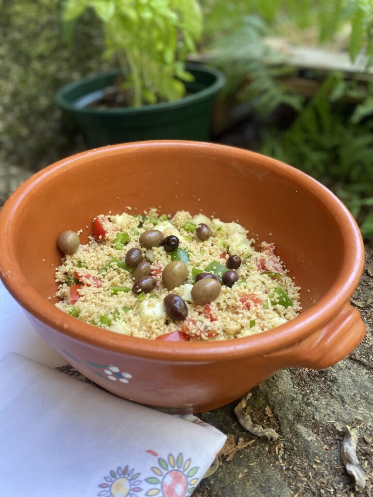 couscous salad in a clay bowl