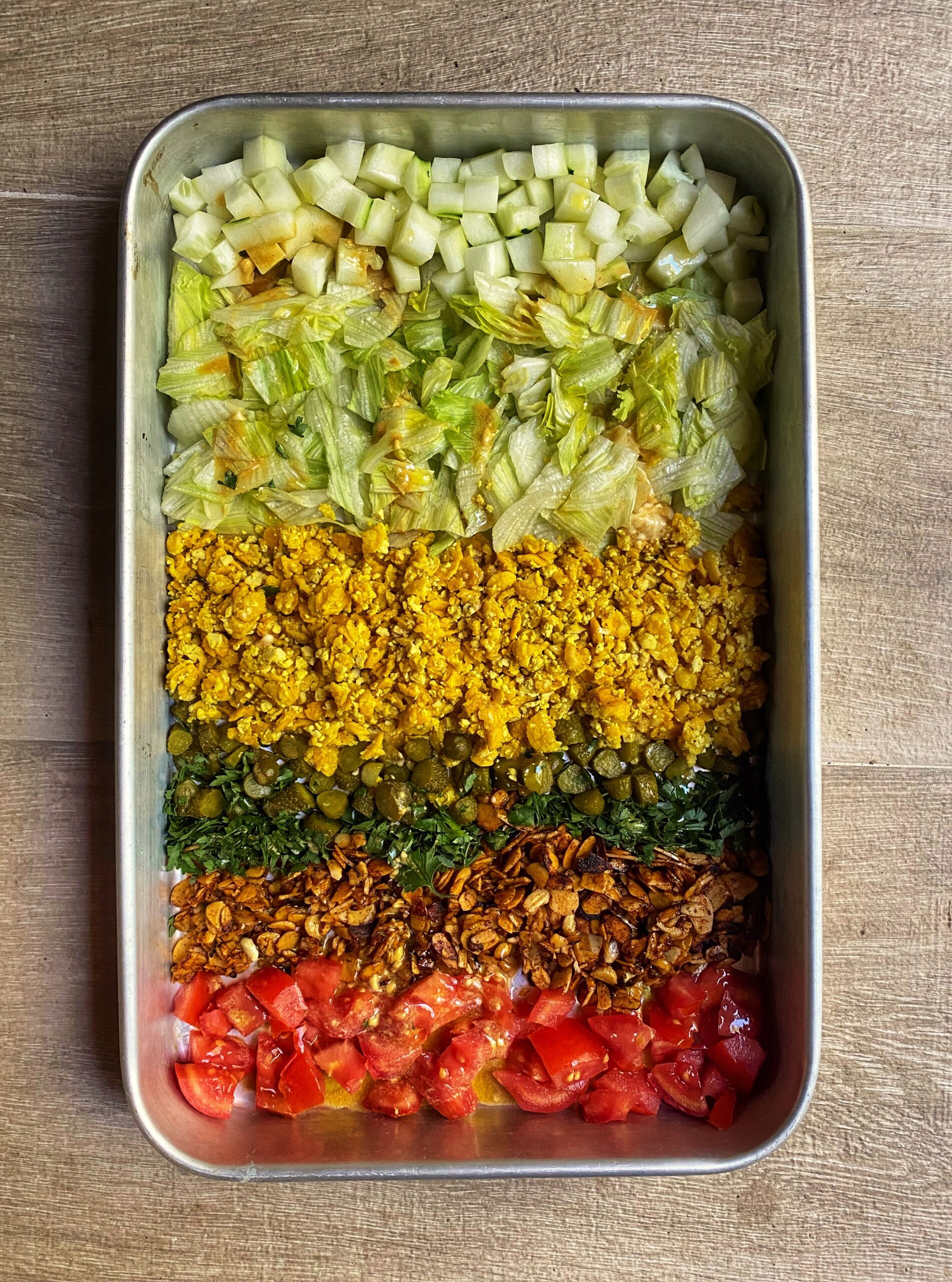 7-Layer-Salad with pan baked almond bacon and vegan scrambled eggs