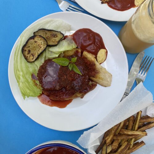 beetroot burgers with sauce on blue background