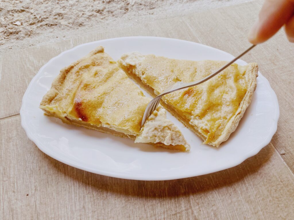 vegan tarte, on a white plate on a stone floor