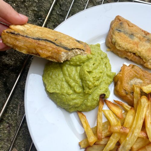 tofish with pea mash on a white plate